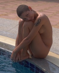 Cute teen posed naked in the pool photo