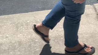 Female friend feet in flip flops coming to see me in public, in motion view