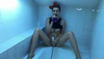 Jolie fille joue avec de l'eau dans la salle de bain et montre son corps